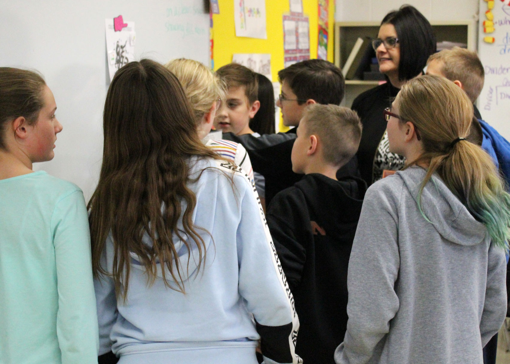 Assenato (right) watches as students organize their evidence and look for logical solutions..jpg